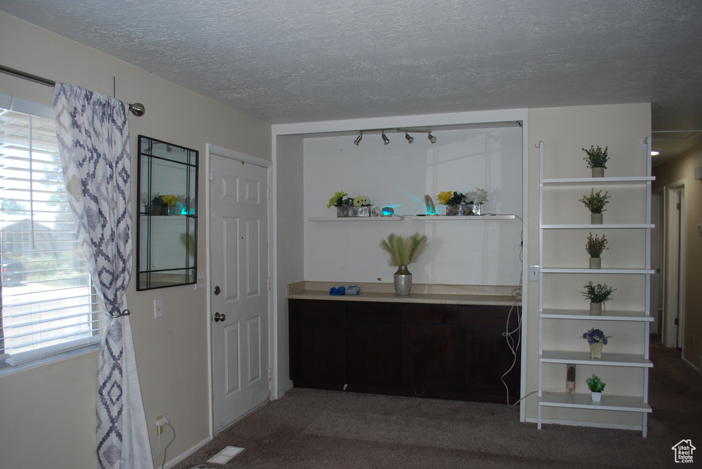Interior space with healthy amount of natural light and a textured ceiling
