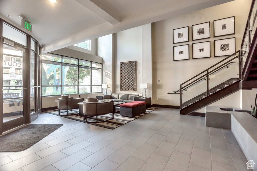 Community lobby featuring stairway and a high ceiling