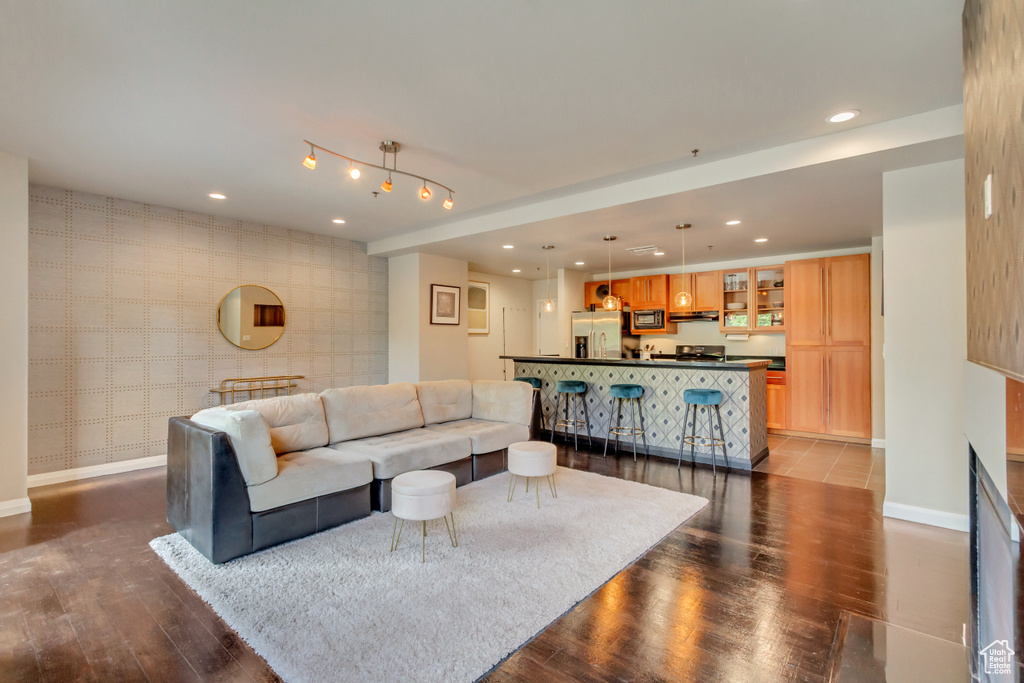 Living room featuring recessed lighting, wood finished floors, and wallpapered walls