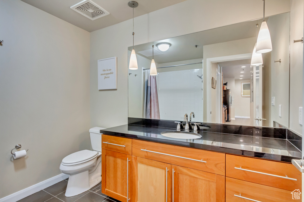 Full bathroom featuring tile patterned flooring, vanity, and a shower with curtain