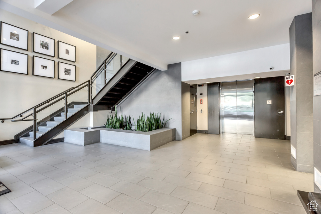 Common area featuring stairway and recessed lighting