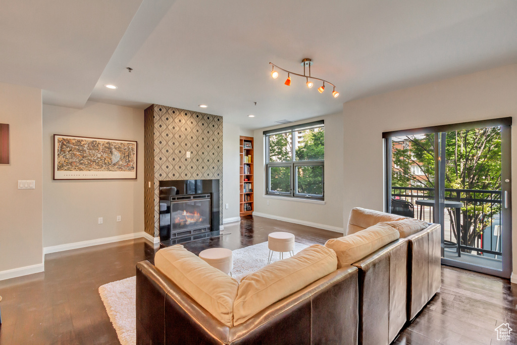 Living room with a tile fireplace, recessed lighting, and wood finished floors
