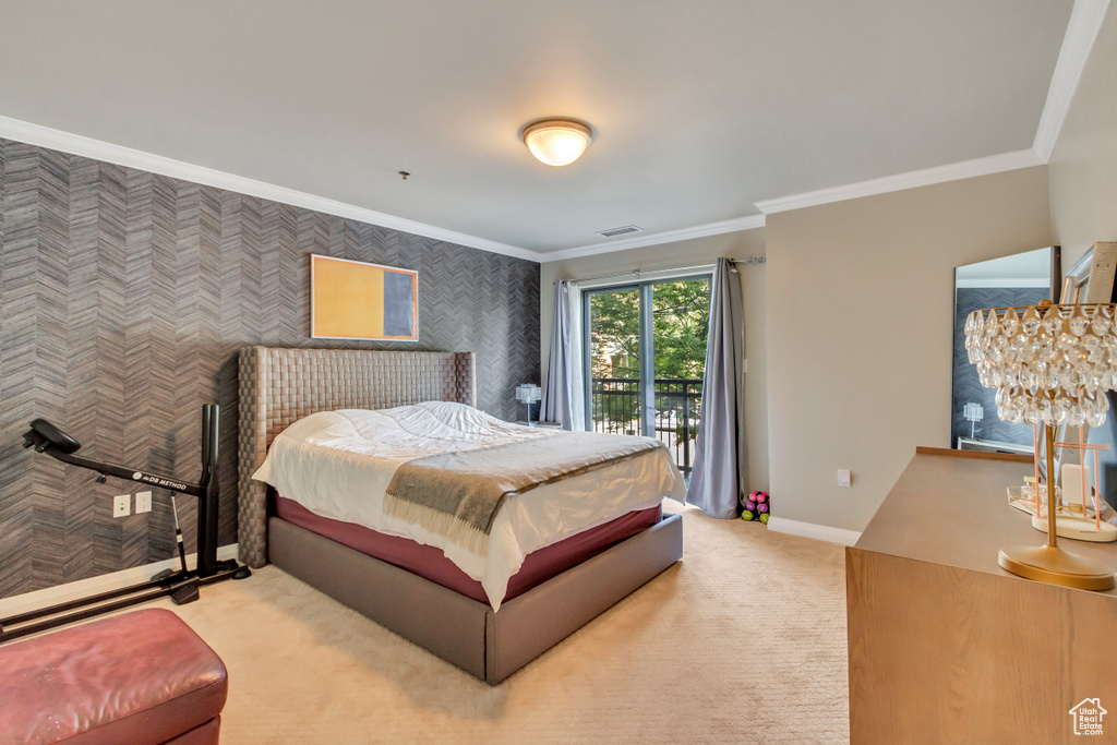 Carpeted bedroom featuring ornamental molding, wallpapered walls, and access to outside