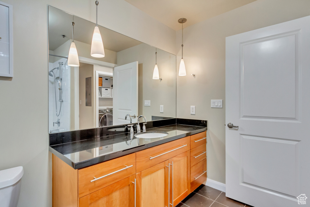 Full bath with vanity, a shower, and tile patterned flooring