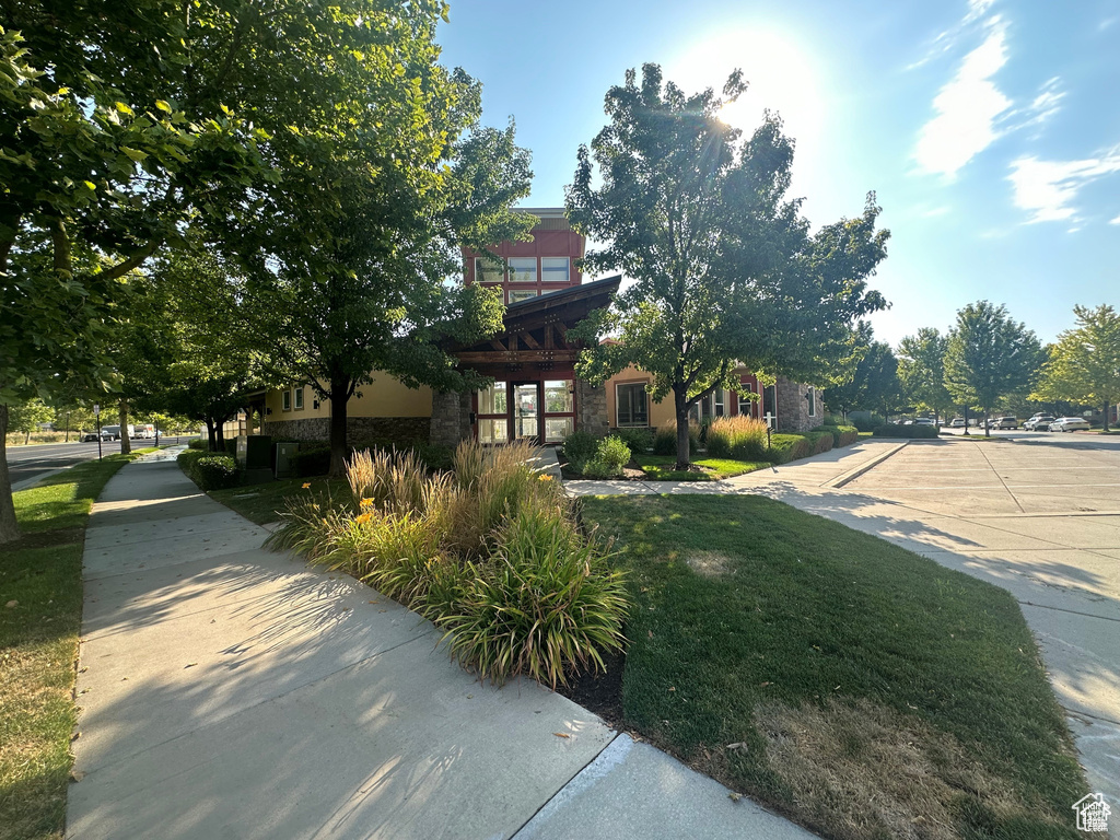 View of front of house with stone siding and driveway