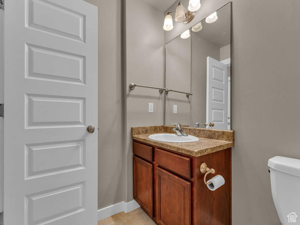 Half bathroom with vanity and toilet
