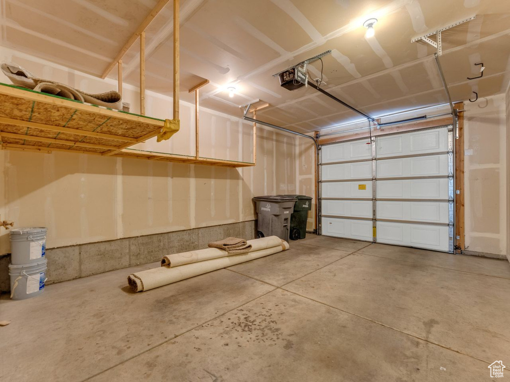 Garage featuring a garage door opener