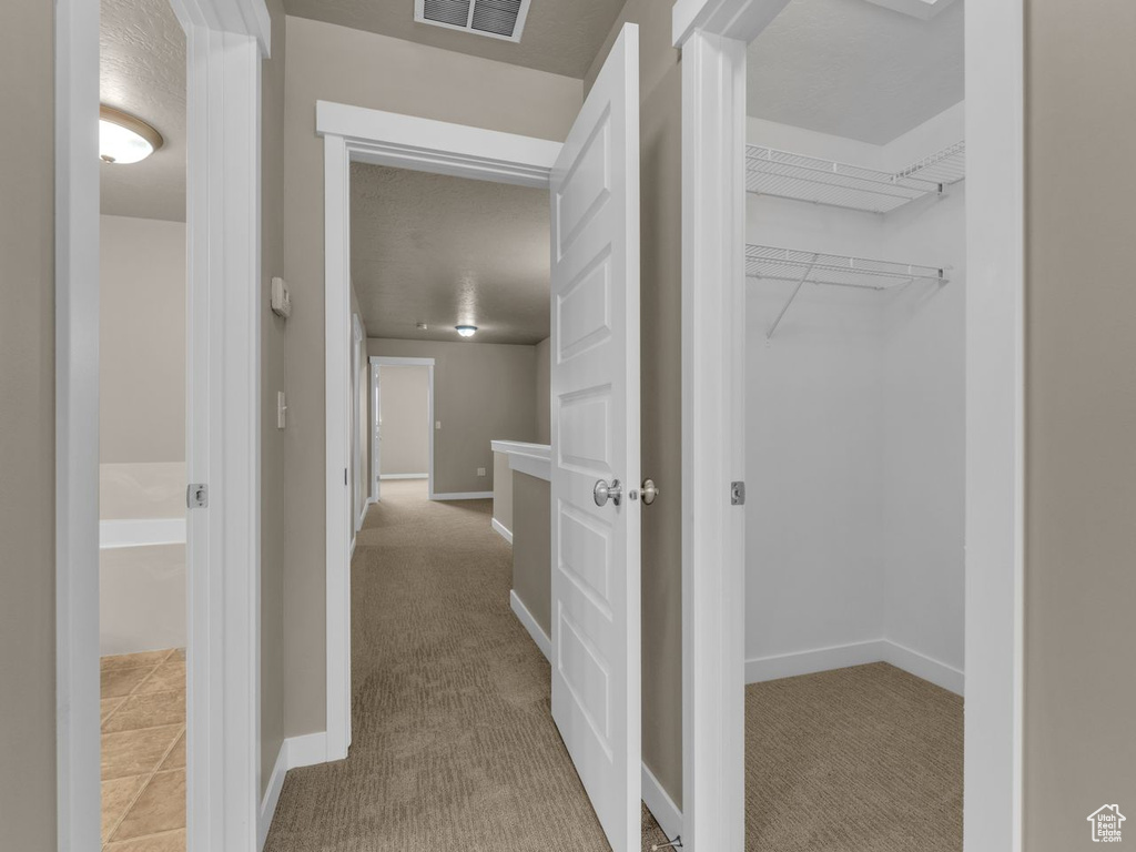 Hallway featuring carpet floors