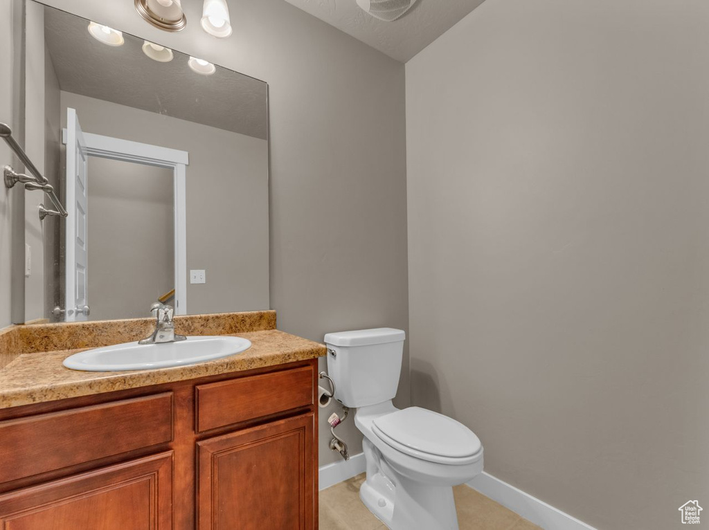 Bathroom with tile patterned floors and vanity