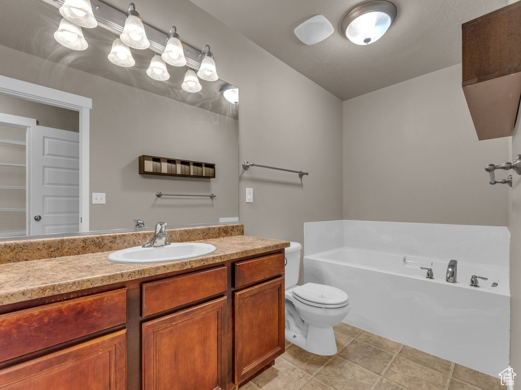 Full bath with a garden tub, vanity, and tile patterned flooring