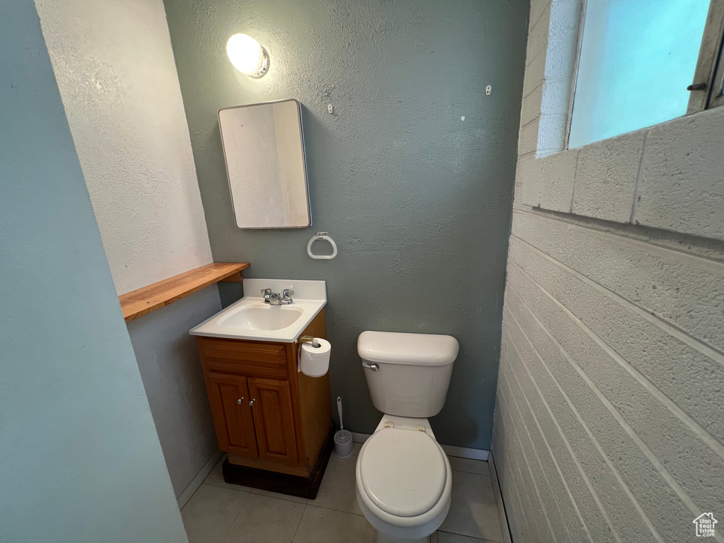 Half bathroom with vanity and tile patterned floors