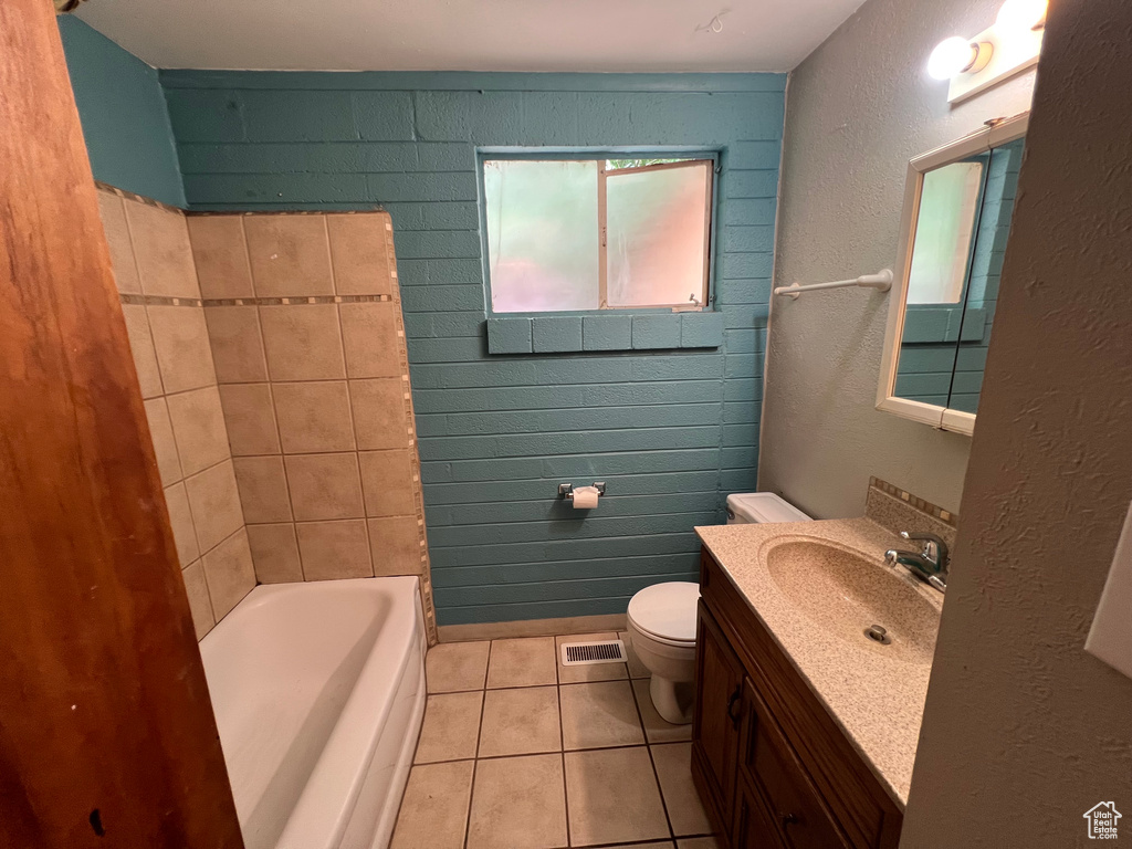 Bathroom with vanity, tile patterned flooring, and a textured wall