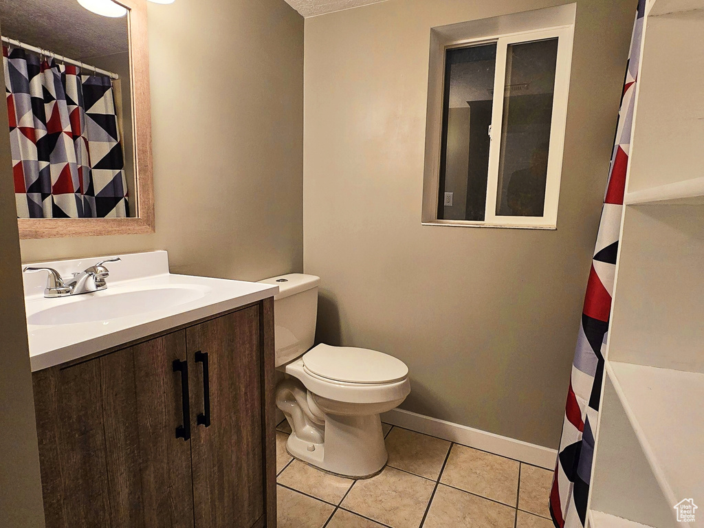 Full bathroom featuring tile patterned flooring and vanity
