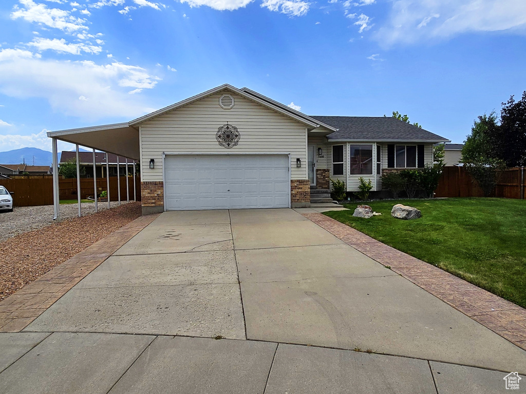 Ranch-style house with driveway, brick siding, and a garage