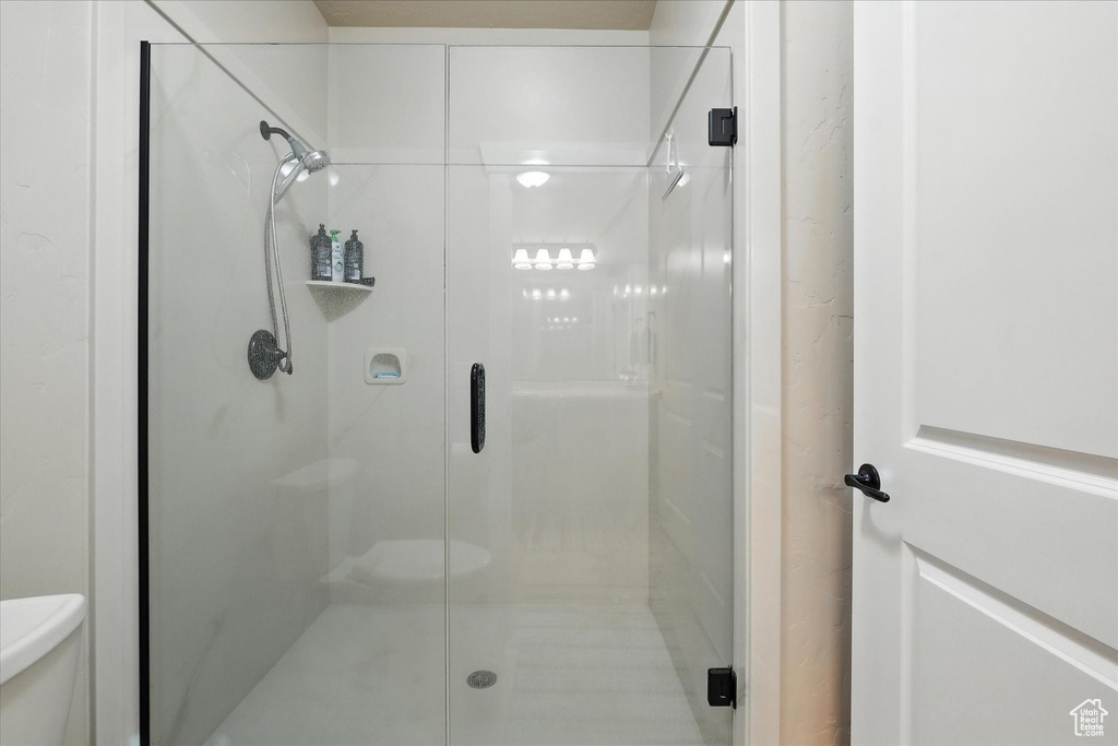 Bathroom with toilet and a stall shower