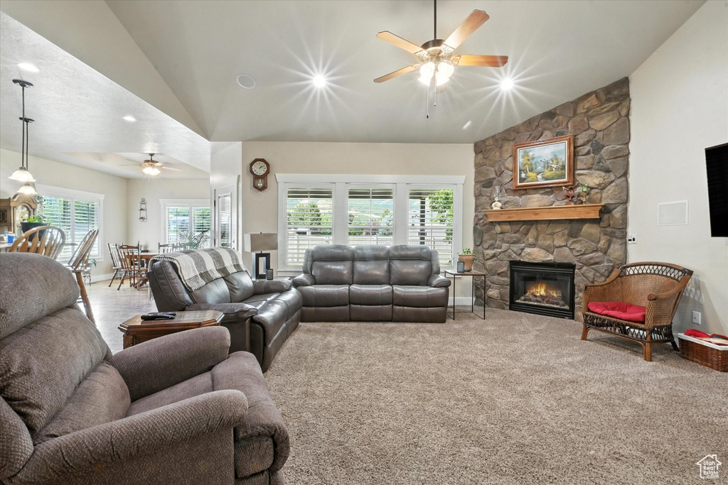Living area with ceiling fan, a fireplace, carpet floors, recessed lighting, and high vaulted ceiling