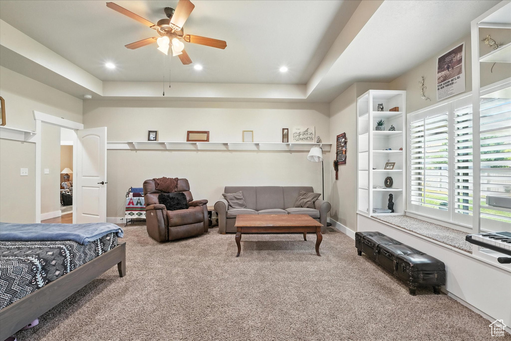 Bedroom featuring carpet floors, a tray ceiling, recessed lighting, and a ceiling fan