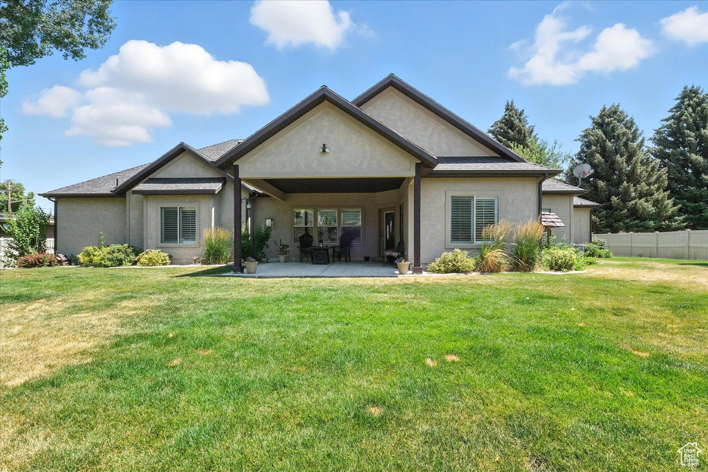 Back of property featuring stucco siding and a patio area
