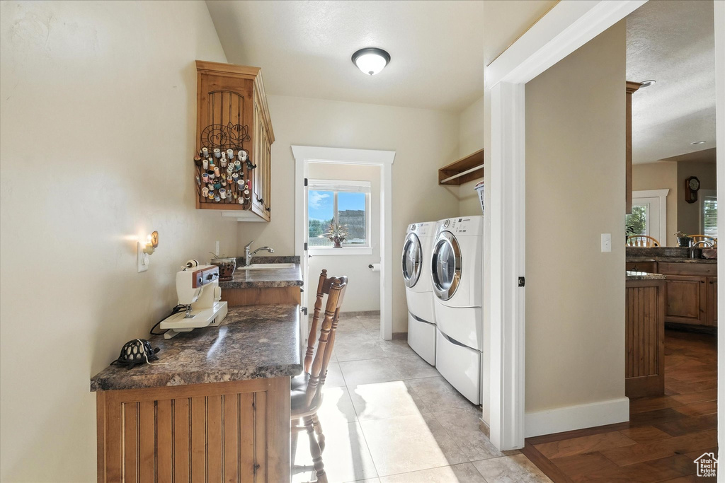 Washroom with washer and clothes dryer and healthy amount of natural light