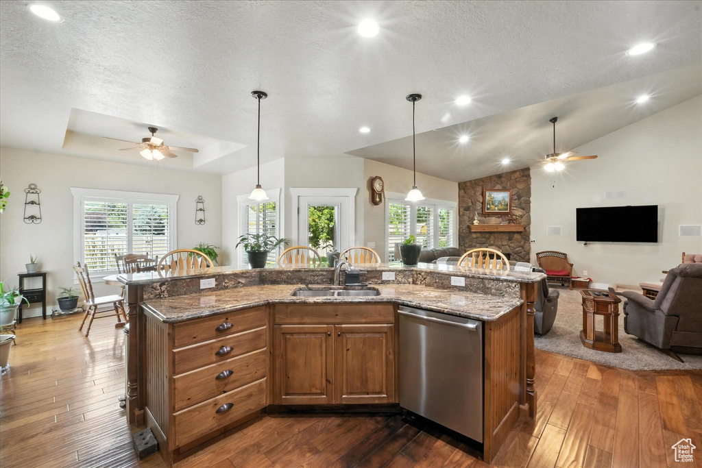 Kitchen with a ceiling fan, open floor plan, dark wood-type flooring, recessed lighting, and lofted ceiling