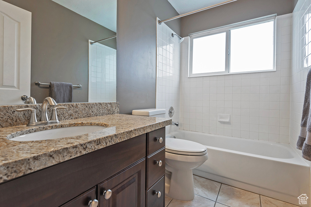 Bathroom featuring vanity,  shower combination, and tile patterned floors