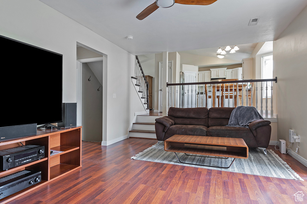 Living room featuring a ceiling fan, wood finished floors, and stairway