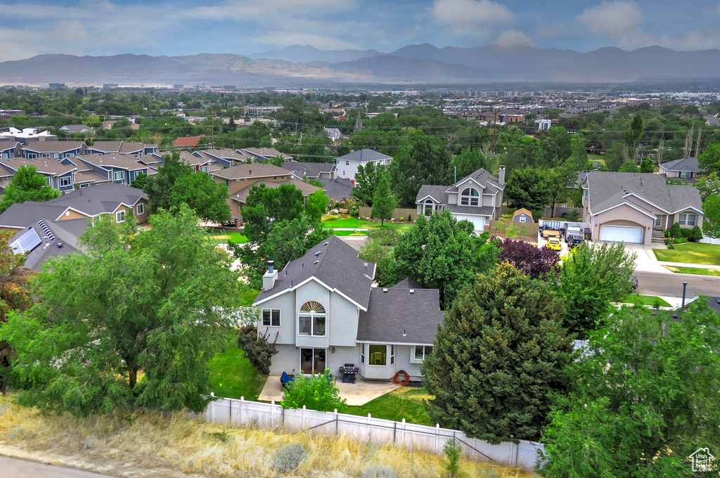 Aerial perspective of suburban area featuring a mountain backdrop