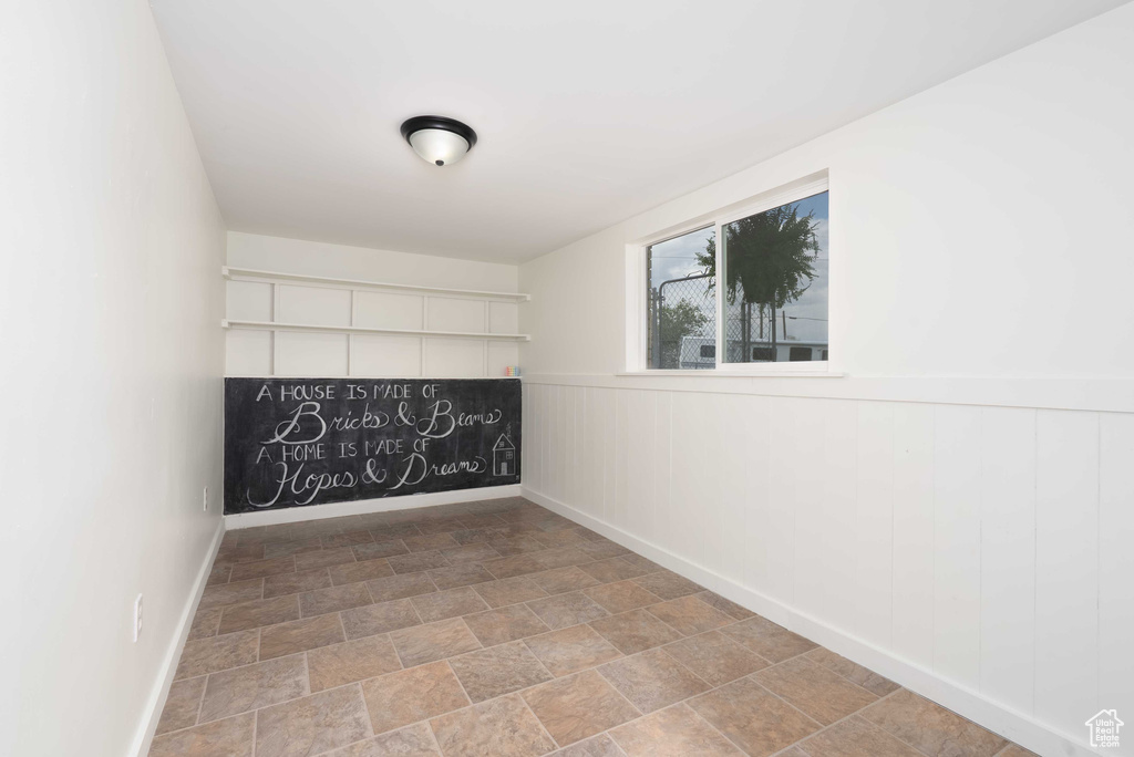 Empty room featuring baseboards and stone finish floors