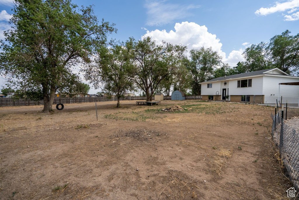 View of yard featuring a storage unit