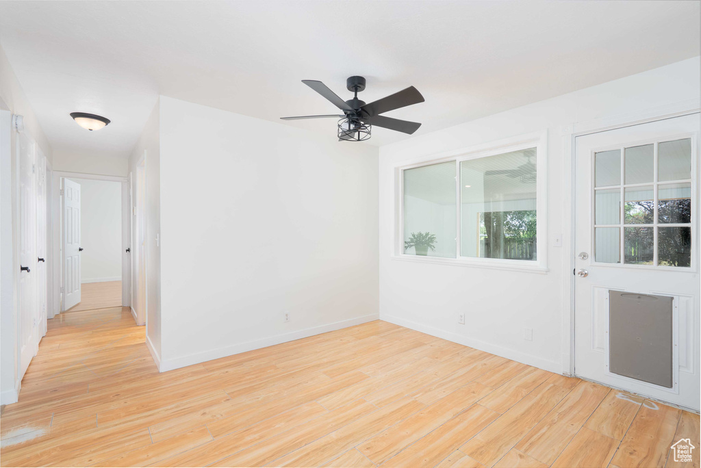 Unfurnished room featuring light wood-type flooring and ceiling fan