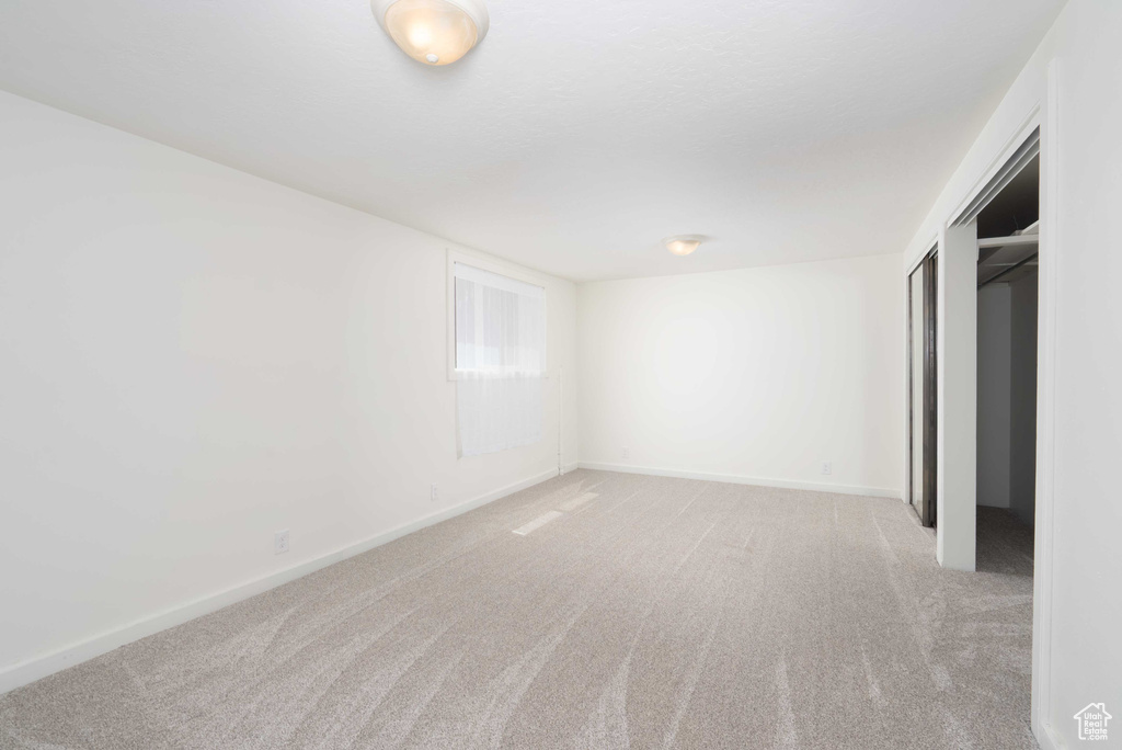 Spare room featuring light colored carpet