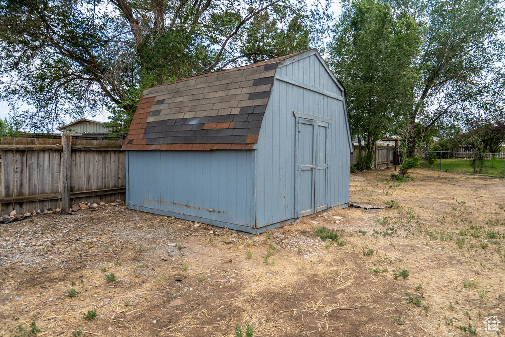 View of shed with a fenced backyard