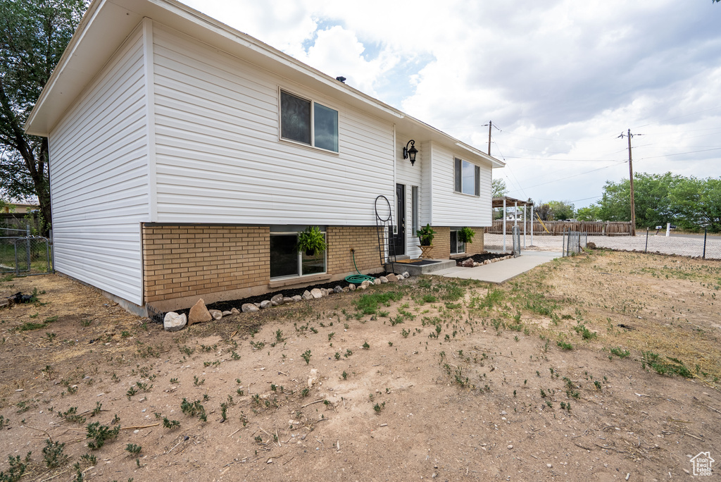 Back of property featuring brick siding