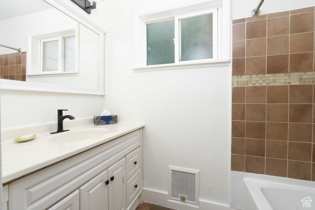 Bathroom with vanity and shower / tub combination