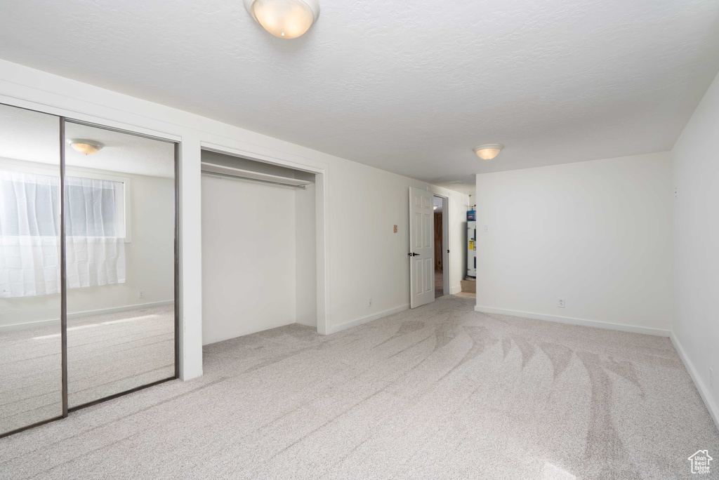 Unfurnished bedroom with two closets and carpet