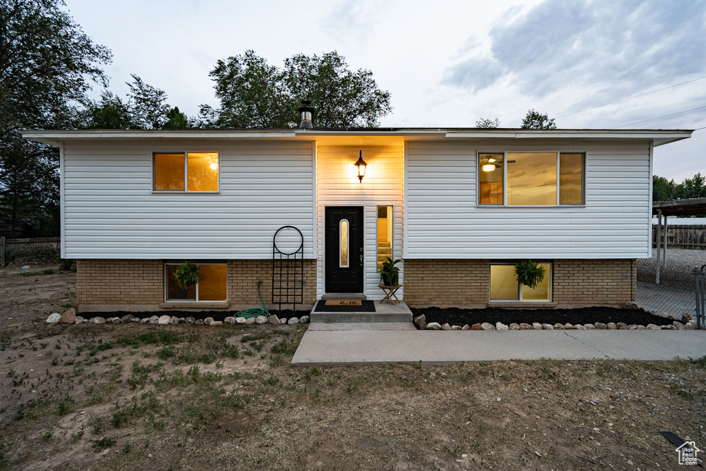 Raised ranch featuring brick siding