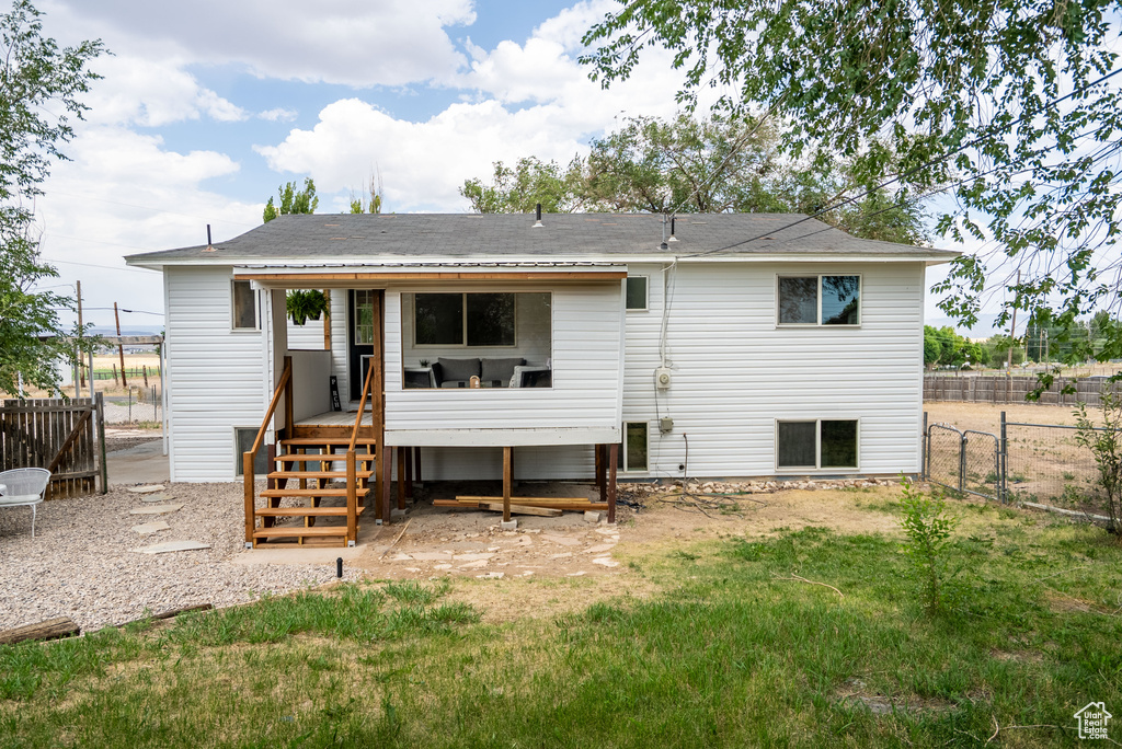 Rear view of house with stairs and a wooden deck