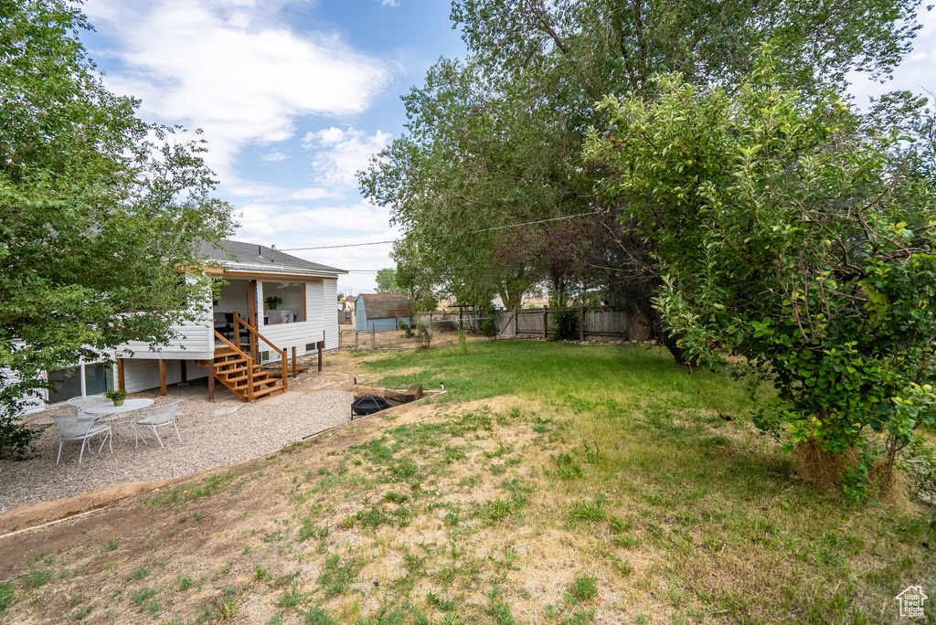 Fenced backyard with a patio area and a deck