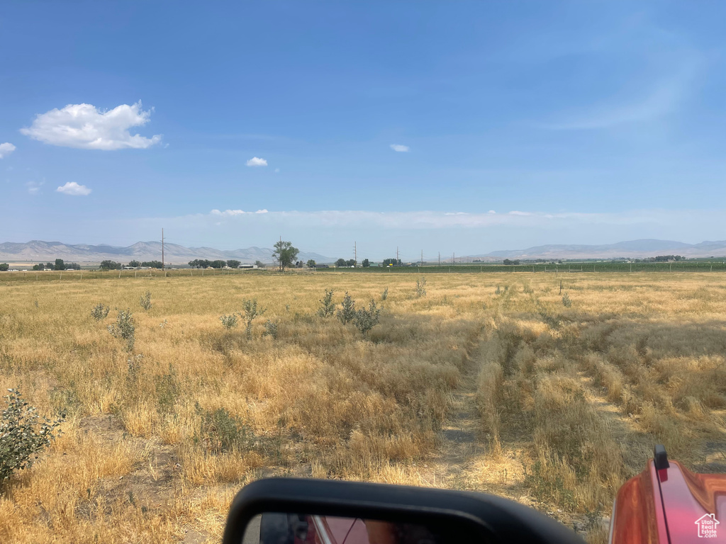 View of yard featuring a rural view and a mountain view