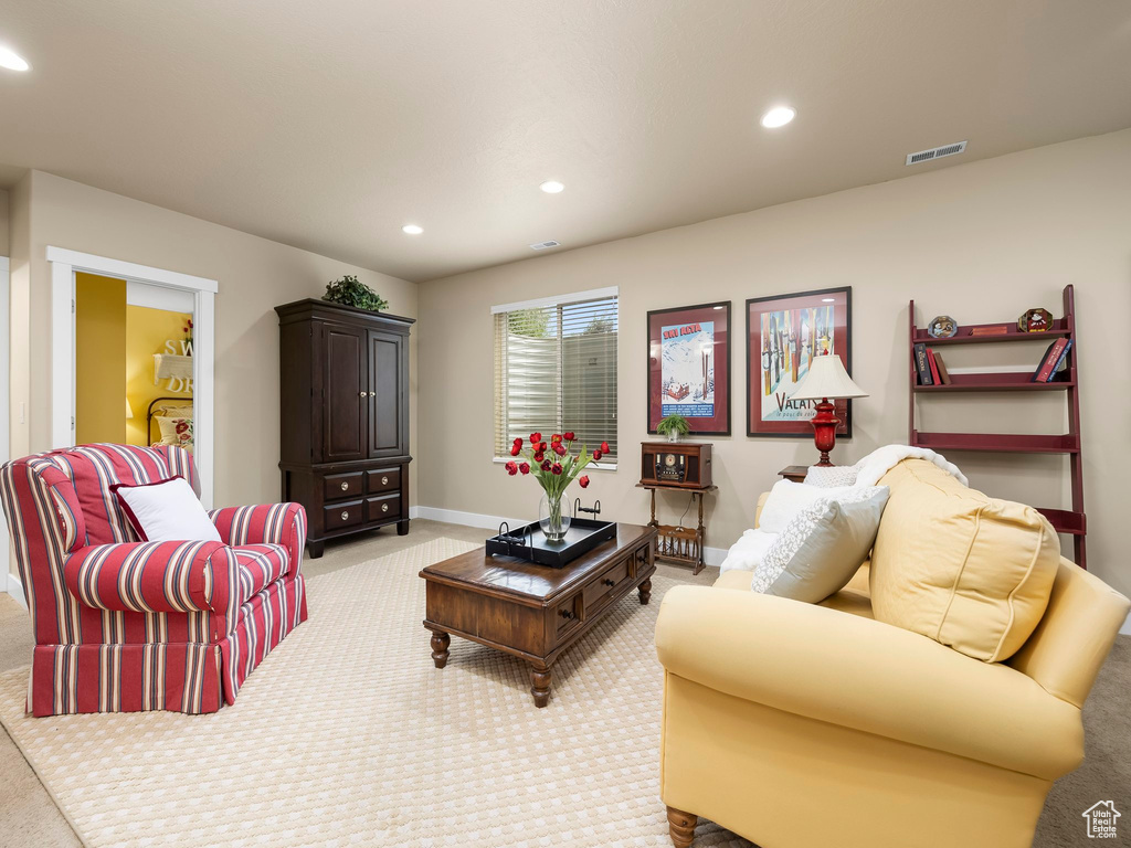 Living room with light colored carpet and recessed lighting