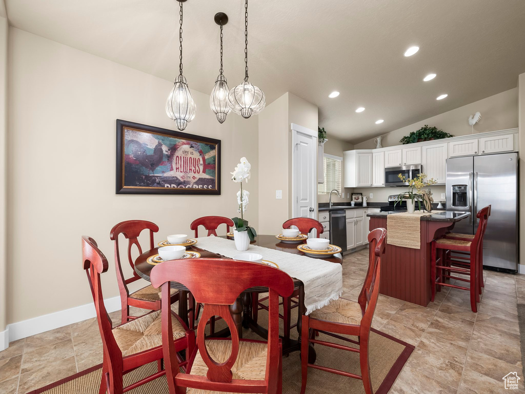 Dining space with recessed lighting and vaulted ceiling