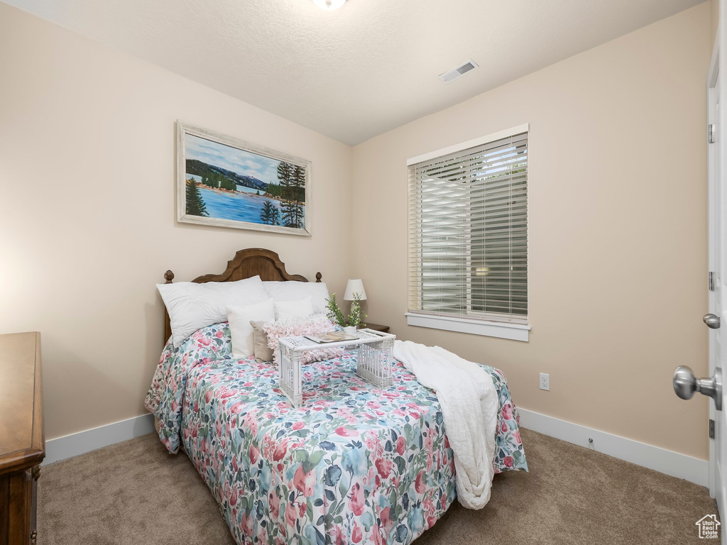 Carpeted bedroom featuring baseboards