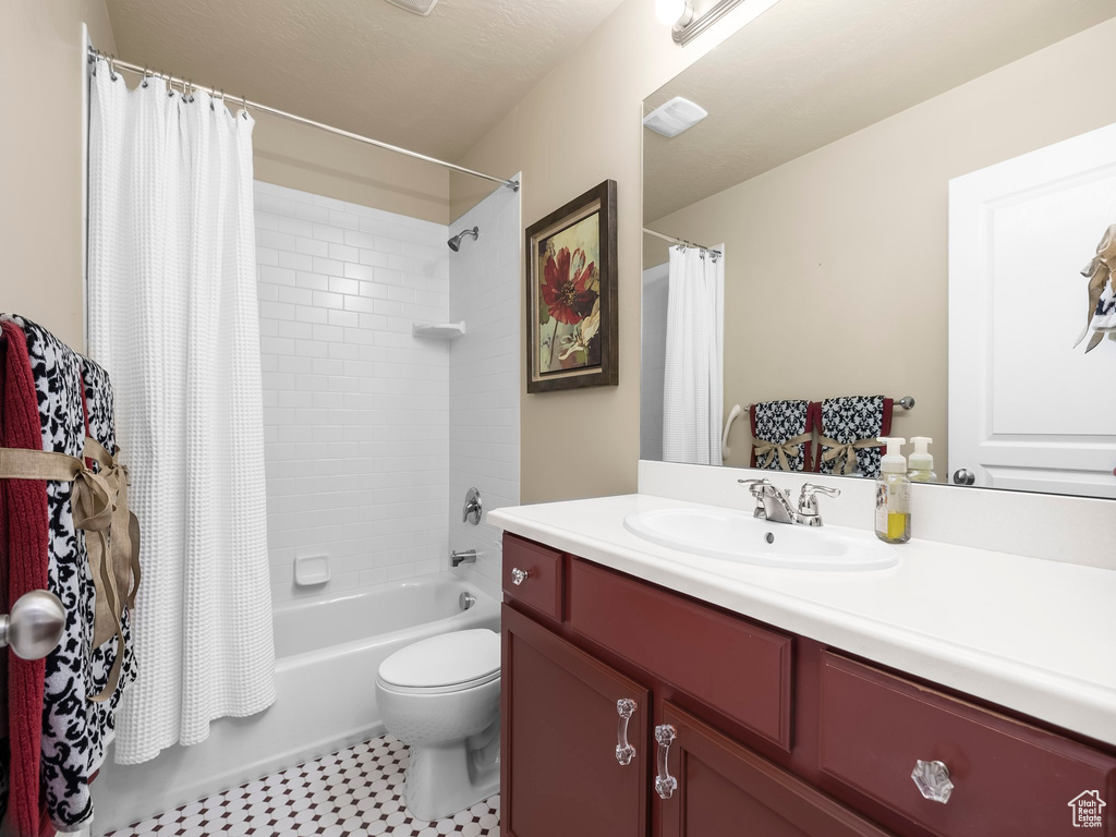 Full bath featuring vanity and shower / bath combination with curtain