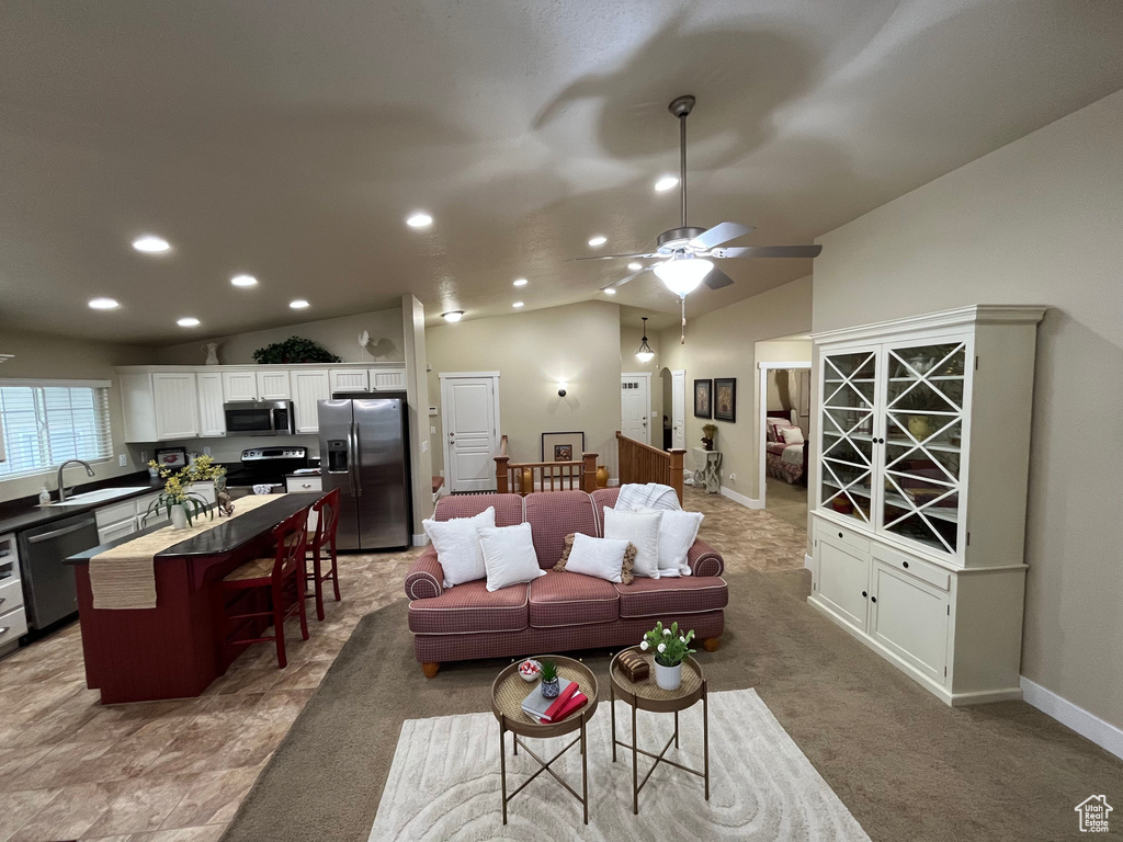 Living room featuring recessed lighting, lofted ceiling, and a ceiling fan