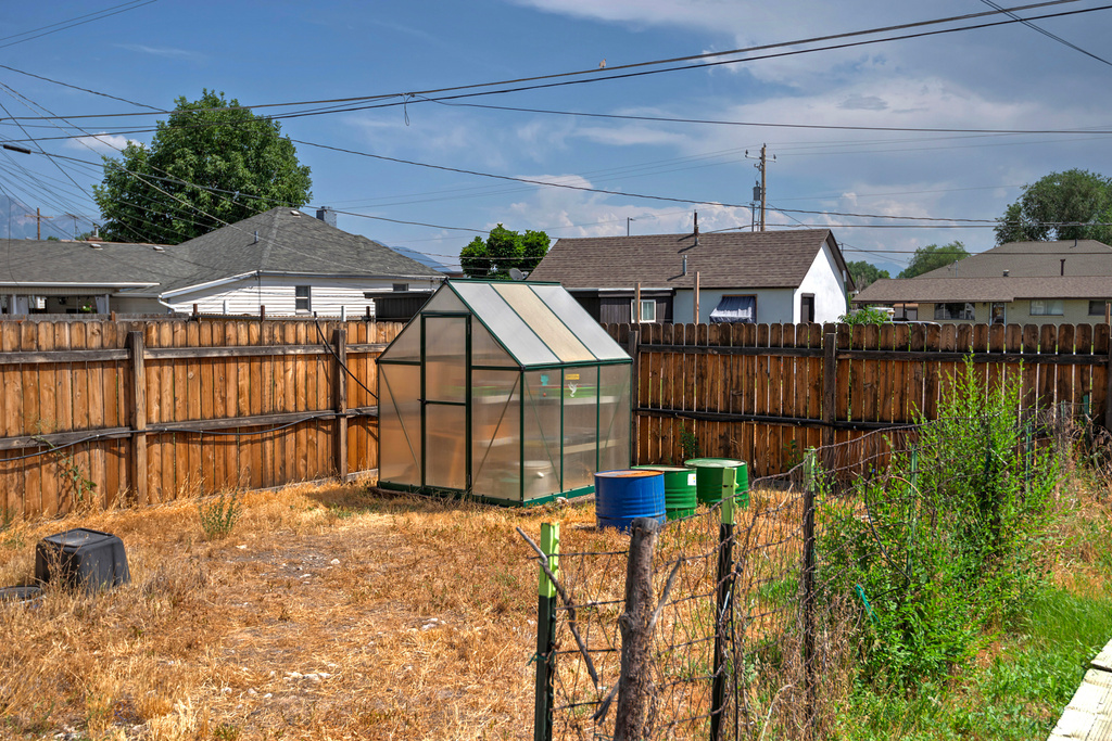 Fenced backyard with an exterior structure and an outdoor structure
