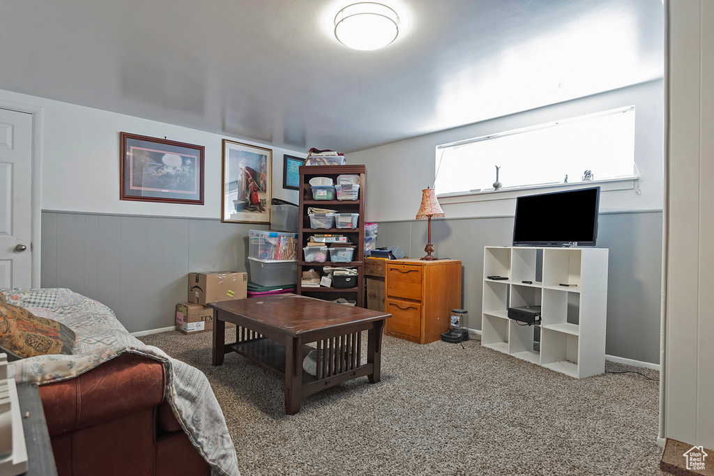 Carpeted office with a wainscoted wall and baseboards
