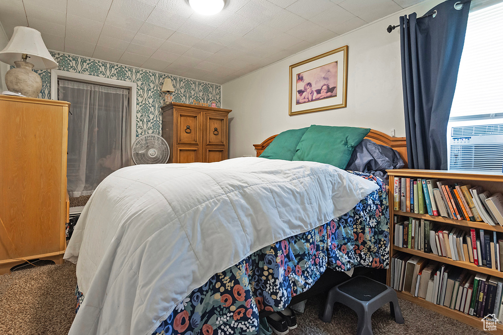 Bedroom featuring wallpapered walls and carpet