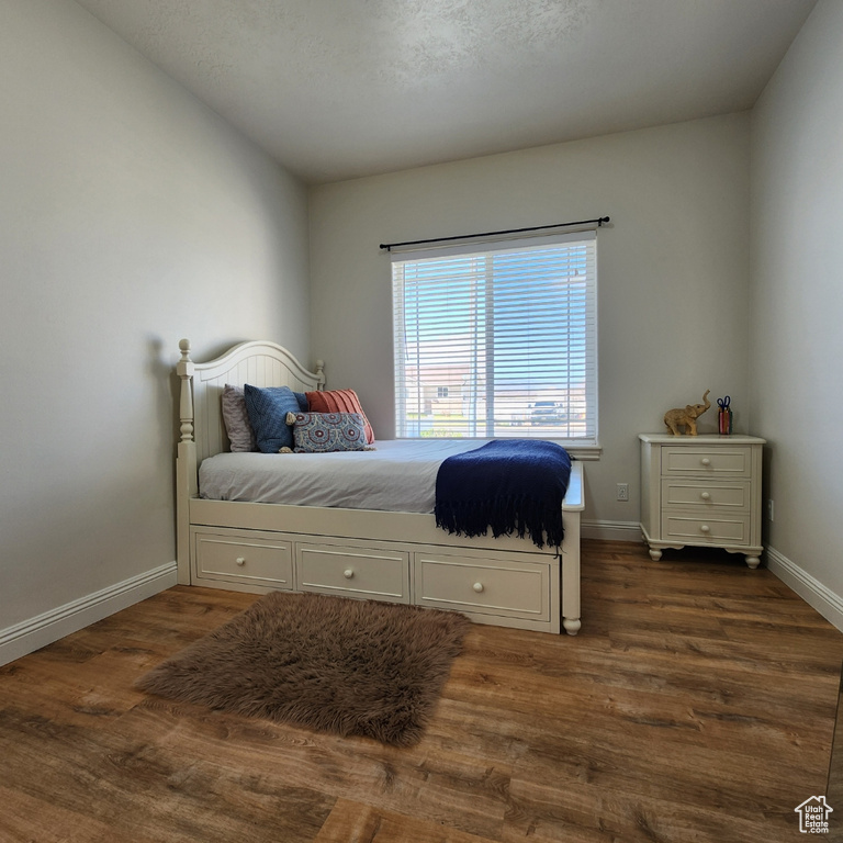Bedroom featuring dark wood-type flooring