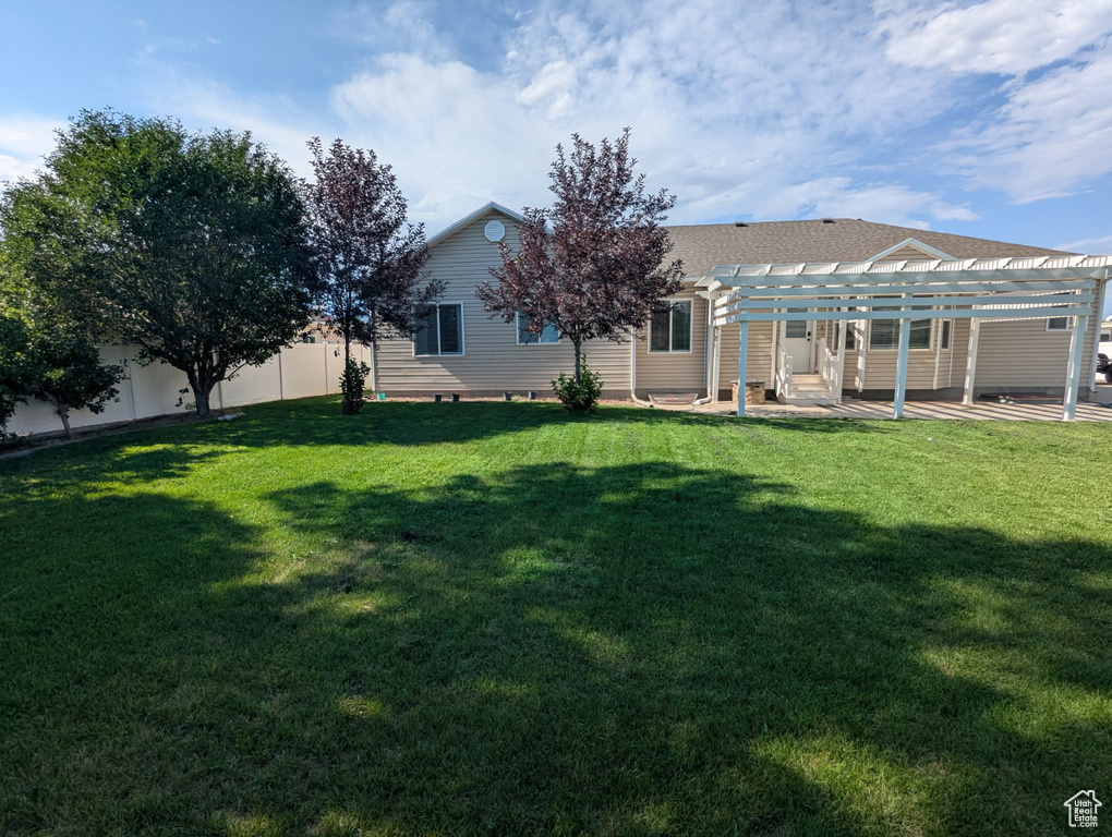 Rear view of property with a pergola, a patio, and a shingled roof