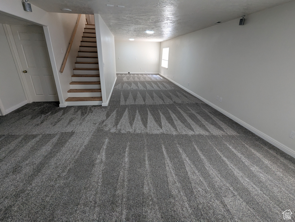 Below grade area with carpet flooring and stairway